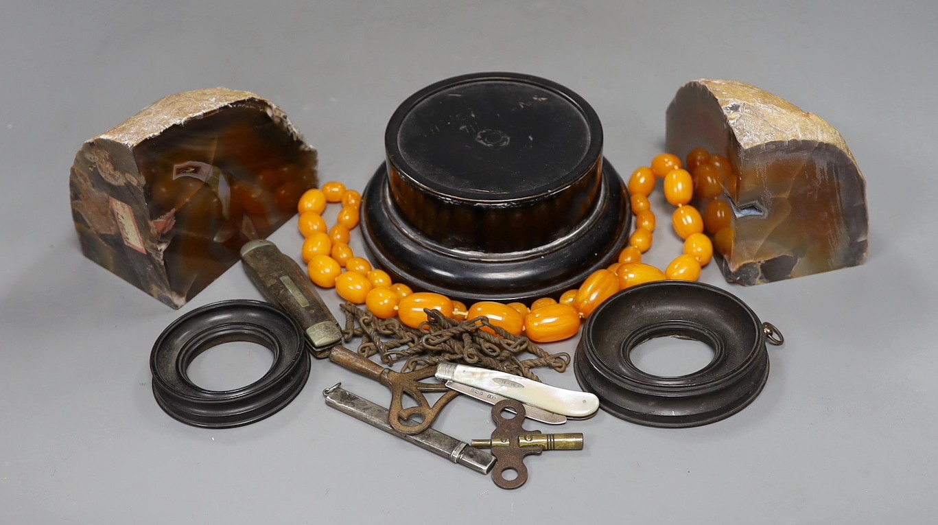 Mixed collectables including a pair of agate bookends, a mother of pearl handled silver fruit knife, faux amber necklace, hardwood stands etc.